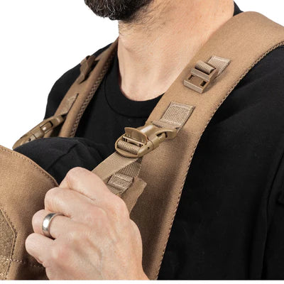 Close-up of a durable, khaki-colored tactical baby carrier strap with robust buckles.