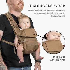 Man wearing Coyote Brown baby carrier with outwards facing infant. Close up on spit up bib. 