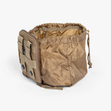 Rugged tan parent backpack with multiple pouches, adjustable cords, and military-inspired design for modern parenting gear.