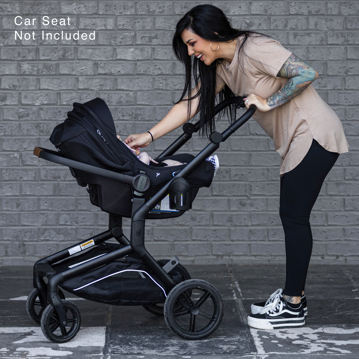 Rugged S-1 Stroller with Newborn Bundle, featuring a parent adjusting the stroller with a baby inside.