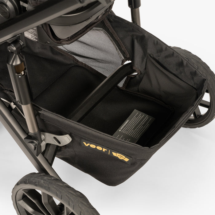 Baby carrier system with multiple components including a stroller base and portable infant basket, displayed on a plain background.