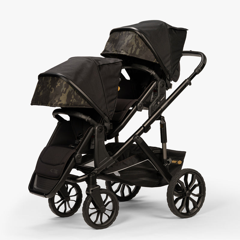 Double stroller with canopies from the TBG Veer Switchback 2 Seat Bundle, viewed from a three-quarter angle.