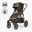 Baby carrier in three-quarter view featuring the TBG Veer Switchback Newborn Bundle, with an infant insert and adjustable straps, shown in a neutral color setting.
