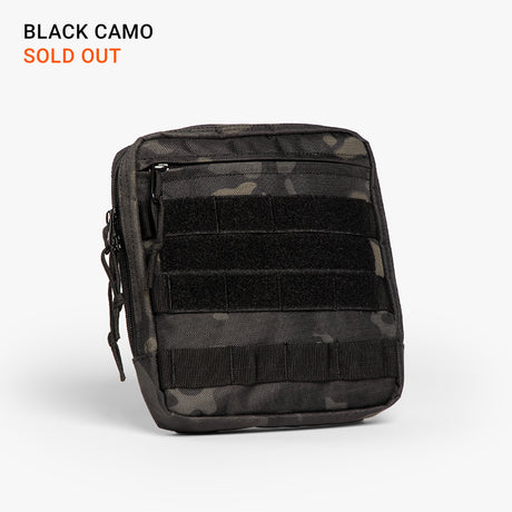 Black camouflage tactical diaper bag with multiple zippered compartments and MOLLE webbing for rugged parenting gear.
