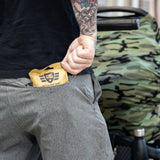 Man in black shirt and grey sweatpants pushing a stroller and pulling an EBOK out of his pocket.