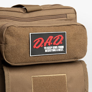 D.A.D. patch on a brown diaper bag