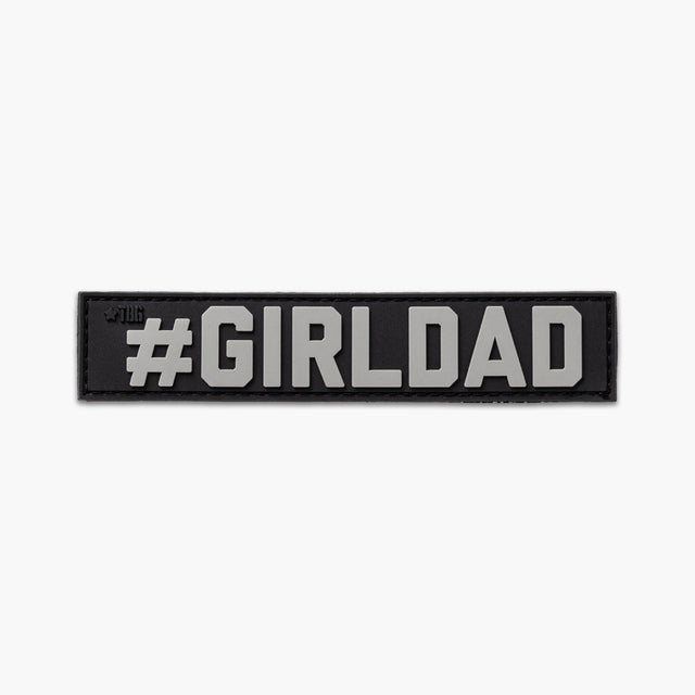 Black name tape with gray lettering reading #GIRLDAD