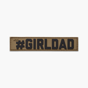 Brown name tape with black lettering reading #GIRLDAD