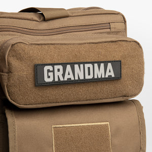 Black GRANDMA name tape on brown diaper bag backpack. 