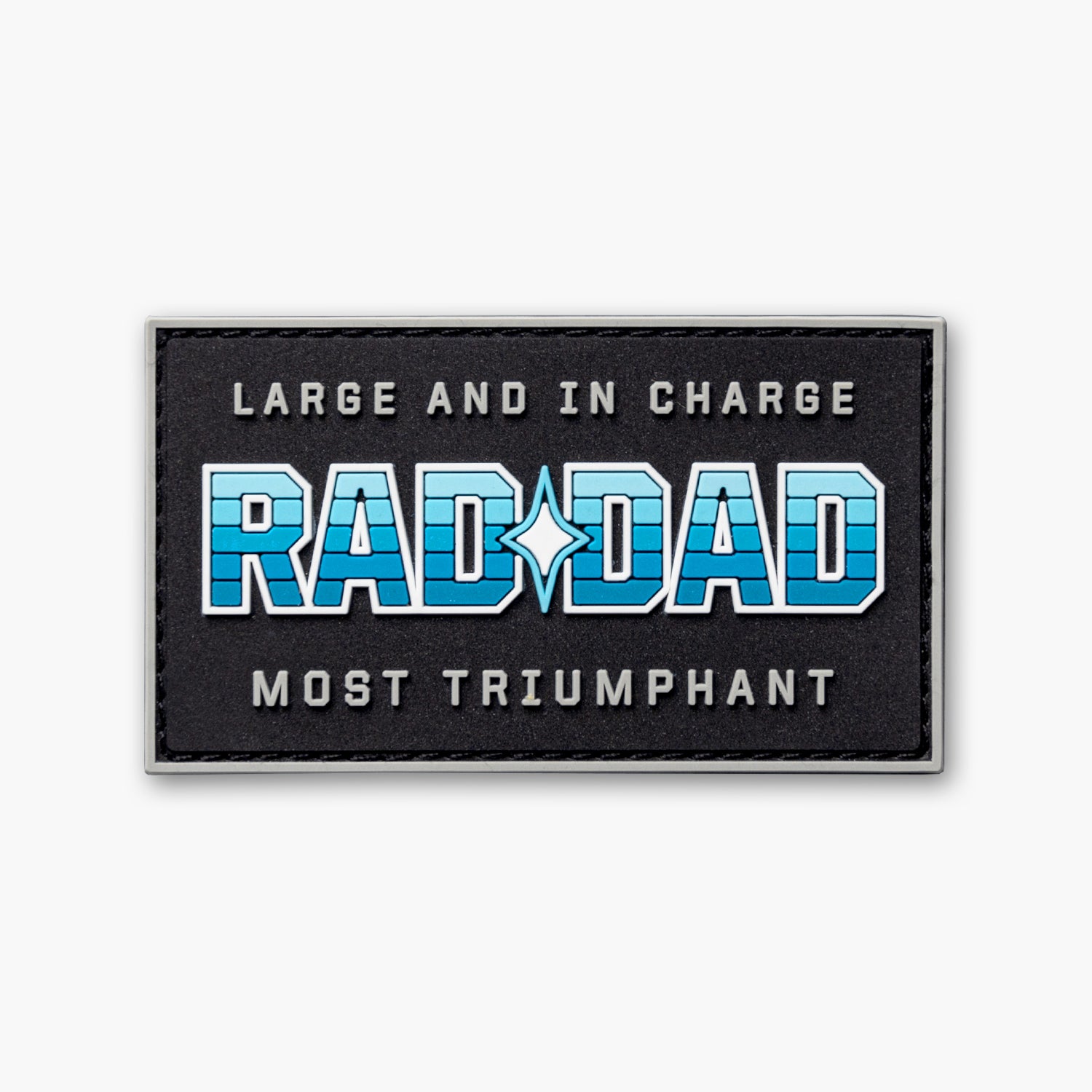 Black patch with white and blue lettering reading Large and in Charge Rad Dad Most Triumphant