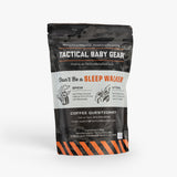 Black and gray resealable pouch of Tactical Baby Gear coffee mix with orange accents, military-inspired design, and brewin...