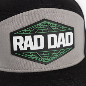 Close up of green and black Rad Dad patch with white lettering on gray background.
