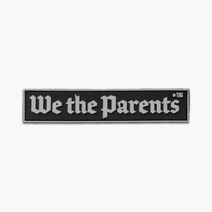 Black patch with gray lettering reading We the Parents in constitutional style script. 