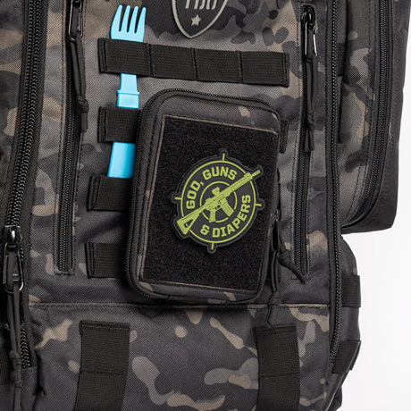 God, Guns & Diapers Crosshairs patch on black camo diaper bag.