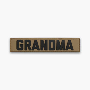 Brown GRANDMA name tape with black lettering. 