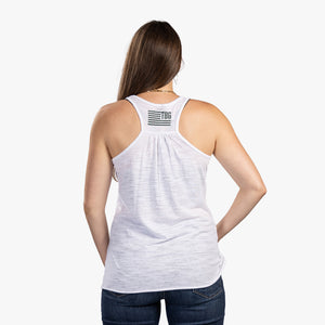 Rear view of woman wearing heather white tank top with TBG flag. 