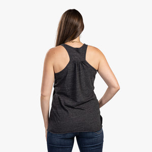 Rear view of brunette woman wearing charcoal Mom Force tank top. 