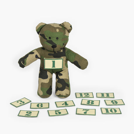 Camouflage teddy bear shown with numbered patches